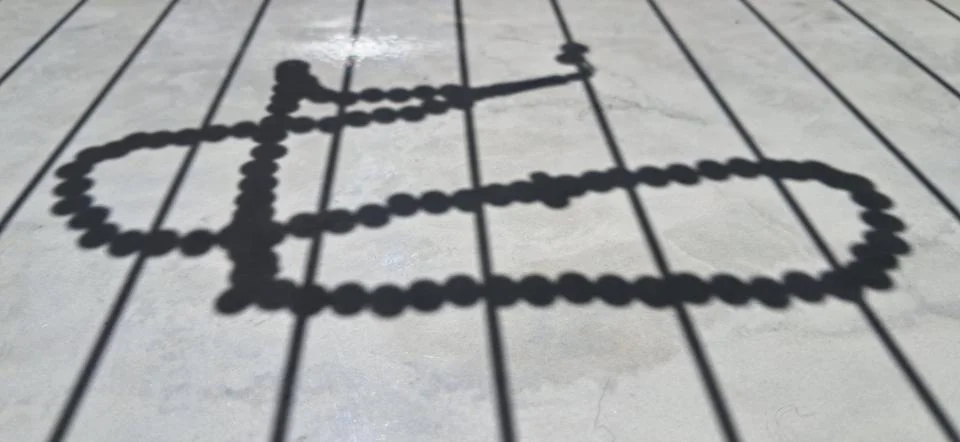 Shadow of prayer beads and vertical lines on surface Stock Photos