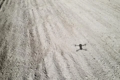 Shadow of a quadrocopter on the ground Stock Photos