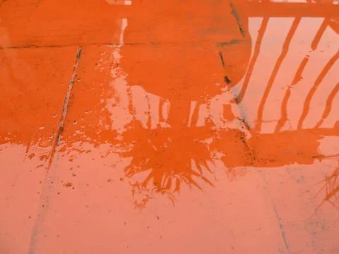 Shadow reflection in puddle Stock Photos