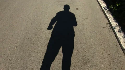 The shadow on the road of a man roller skating, slow motion Stock Footage 162350612