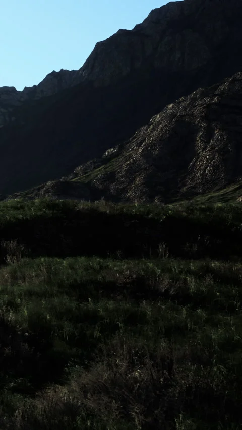 Shadow on a rocky mountain landscape during sunset in a dry region Stock Footage 340886601
