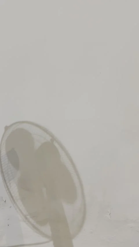Shadow of Rotating Fan on Grungy White Wall Vertical Video Stock Footage 334575144