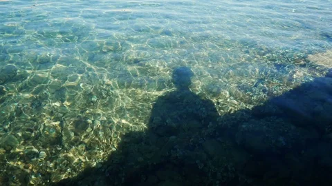 Shadow of seated man on transparent waves Stock Footage 93593288