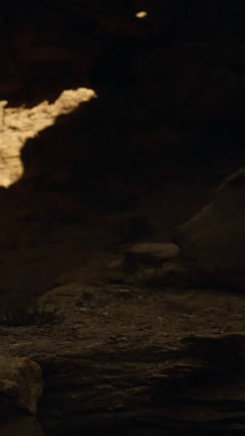 Shadow shapes on rocks in a cave with natural light casting patterns Stock Footage 334199422