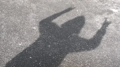 Shadow silhouette of a hooded man dancing Stock Footage 129792868