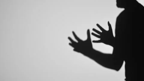 Shadow Silhouette of Raised Hands on a Light Background Stock Footage 311933102