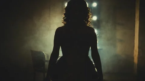 Shadow silhouette retro lady walking in dark black room fool smoke mirror with Stock Footage 325567060