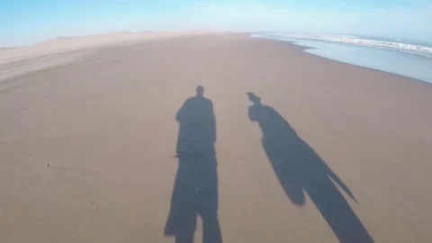 Shadow silhouettes of two people walking. Stock Footage 150772062