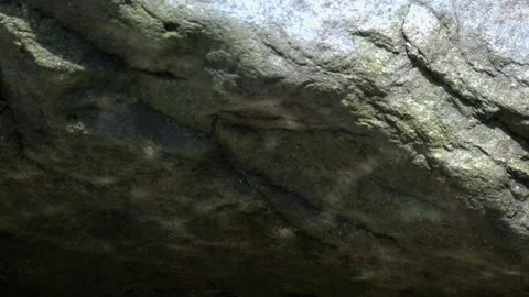 Shadow of sparkling water light on a large rock Video stock 297656334