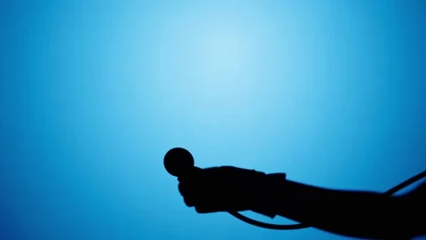 Shadow of stethoscope on blue neon background. Doctor holding medical equipment Video stock 170735426