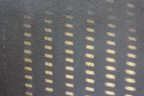 Shadow on the stone wall of the balcony. Stock Photos