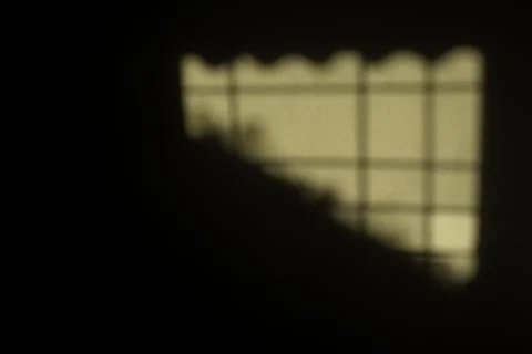 Shadow of the sun shining on the wall of the house during the golden hour Fotos de archivo