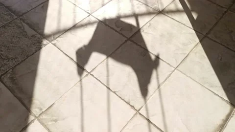 Shadow of the swing swinging in the wind on the balcony floor Stock Footage 213967202