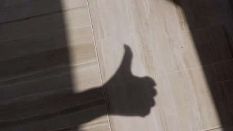 Shadow of Thumbs Up on Tiled Floor Stock-Footage 317563650