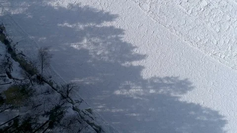 Shadow of trees on frozen River, Overhead drone footage Stock Footage 87937295