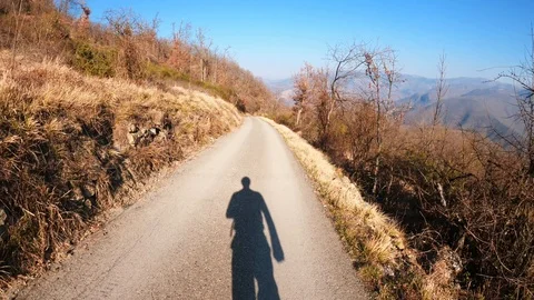 Shadow of a trekker running on forest trail Stock Footage 128156506