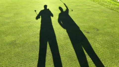 Shadow of Two Golfers Hand Shake on the Putting Green on the Golf Course Stock Footage 272762446
