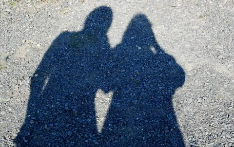 Shadow of two people with heart Stock Photos