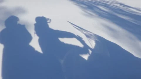 Shadow of Two People Riding Snowmobile on Snow  Stock Footage 333107476