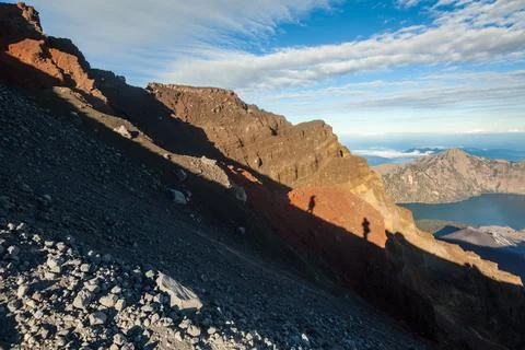 Shadow of two people on the volcanic surface on top of the Mount Rinjani, Lombok Stock Photos