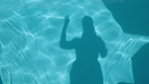 Shadow of two people waving in the pool Stock Footage 341773597