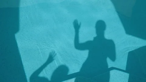 Shadow of two people waving in the pool Stock Footage 341773604