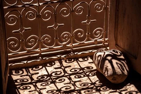 Shadow of an typical ornate window grid falling onto a stone, a kasbah at t.. Stock Photos