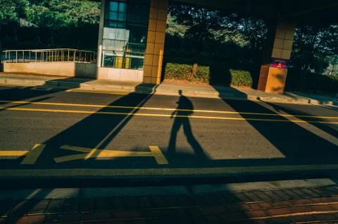 Shadow of walking guy Stock Photos