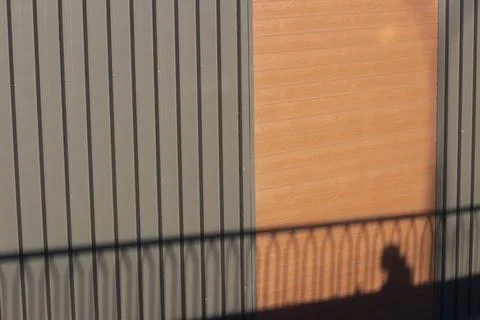 Shadow on the wall. Black shadows on a bright day. Stock Photos
