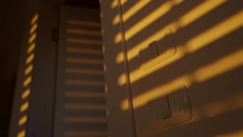 Shadow on a wall of electric or mechanical window opening or rolling up in 動画素材 310373692