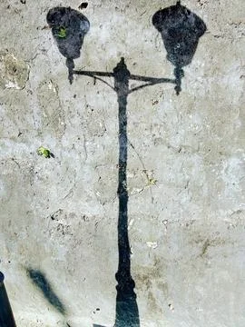Shadow on the wall from a lamppost Stock Photos