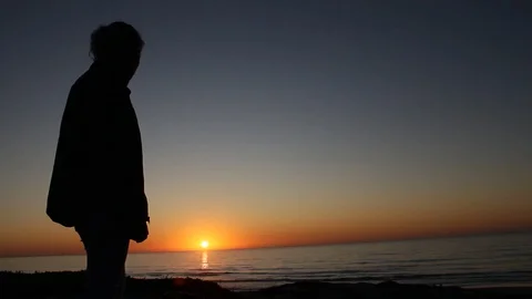 Shadow watching sun set Stock Footage 123200959
