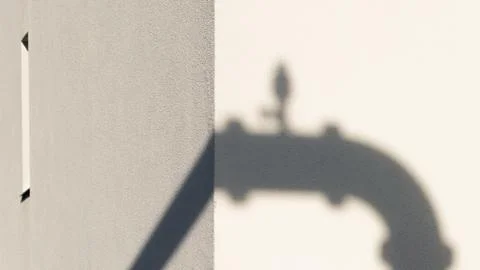 Shadow of a water pipe with a window Stock Photos