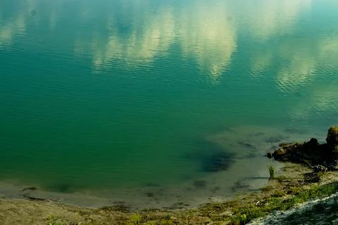 The shadow of white clouds has been created on the blue water Stock Photos