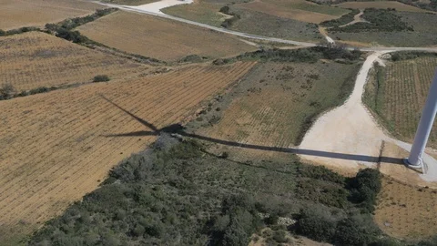 Shadow of wind turbine creating pattern on the farmland below Stock Footage 102515625