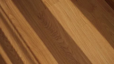 Shadow from window and curtain created on wooden floor as wind blows fabric Stock Footage 339058539