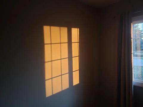 A shadow of a window on a indoor wall Stock Photos