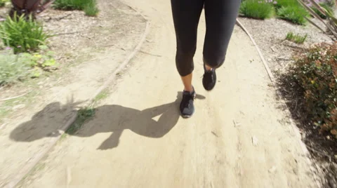 Shadow of woman running on path Video stock 49616374