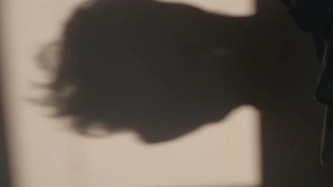 Shadow woman touch and play with her hair, elegant and mysterious shot. ochre Stock Footage 171982965
