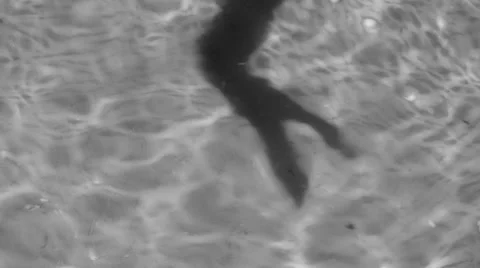 Shadow of a woman's hand dancing on the water, black and white Stock Footage
