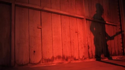 Shadow on a wooden wall of a man playing guitar. Stock Footage 88341806