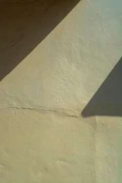 Shadow on yellow concrete wall, texture image Stock Photos