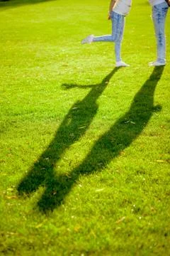 The shadow of a young couple on the grass Stock Photos