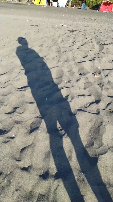 Shadow of young person at the beach Stock Footage 137668532