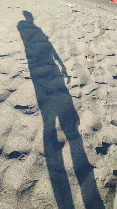 Shadow of young person at the beach Stock Footage 137668553