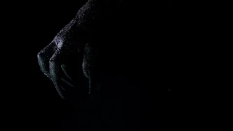 Shadow of a zombie hand on black background Stock Footage 317943304