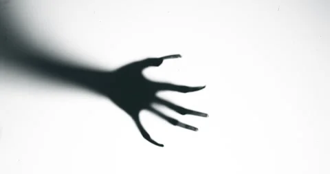 Shadow of a zombie hand on white background Stock Footage 276660526