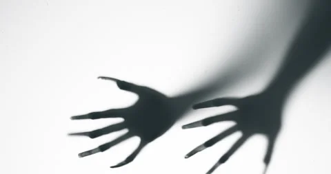 Shadow of a zombie hand on white background Stock Footage 296563515