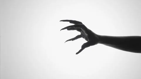 Shadow of a zombie hand on white background Stock Footage 317882171