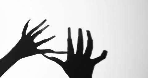 Shadow of a zombie hand on white background Stock Footage 338442005